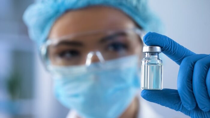 Female,biologist,holding,bottle,with,new,medication,,vaccination,lab,research